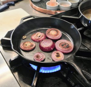 The onions are cooked on medium-high heat until they are lightly charred - about four minutes each side.
