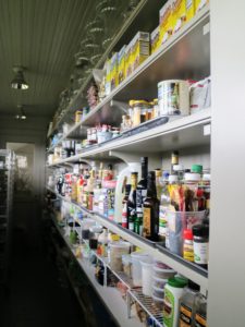 In the back of the Flower Room is this long hall pantry. Long, sturdy shelves line the entire length of the room on one side.