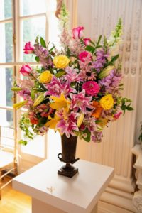 This floral piece was created by Susan Dewey, in Cape Cod, Massachusetts for the "Smart & Sunny" class. Her arrangement has triple stargazer lilies, roses, and lots of sun-loving flowers. (Photo courtesy of The Preservation Society of Newport County)