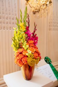 This colorful display is by Michelle Mensinger in Derry, New Hampshire. It includes roses, gladiolas, and yarrow. It received the Newport Flower Show new exhibitor award for floral design and most distinctive entry by a first-time exhibitor.