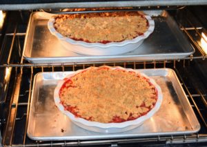 Coming out of the oven are these two gorgeous rhubarb crisps. Look at the bold red color of the rhubarb coming through around the crumbled topping.