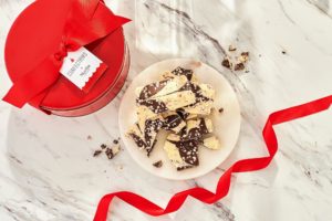 Each tin contains two pounds of this scrumptious treat - and then tied with a festive red bow and gift tag.