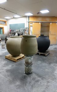 Here are three vessels in different stages of production. It takes about three weeks to make one piece. The first week is the building, the second week is for curing and the last is for coloring.