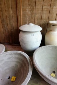 Here is a Luna urn with its winter lid. Lunaform containers can be kept outdoors as long as it is covered during winter, so water doesn't collect inside, freeze, and then crack the concrete.