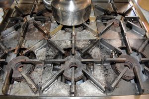 One by one, the grates are returned to the stove top - everything looks very clean.