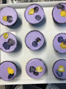 These charming dark chocolate brownie cupcakes have lavender glaze and pretty little edible pansies on top. They'll be in my upcoming "decorated cupcakes" show.