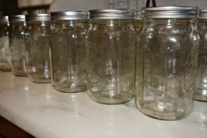 I store lots of Ball mason jars in different sizes for preserving. These quart jars were washed and sterilized in boiling water for at least 15 to 20 minutes to prepare them for the canning process. Be sure to do this with all canning jars and lids. Sterilizing removes the bacteria, yeasts, fungi and organisms from the jar so that the food will remain fresh within the vacuum after canning. https://www.freshpreserving.com/