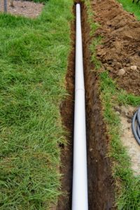 The pipe was installed at the bottom of the two-foot deep trench. Curtain drains are very similar to french drains - they both direct water away from an area. A french drain focuses on ground water, while a more shallow curtain drain deals more with surface water.