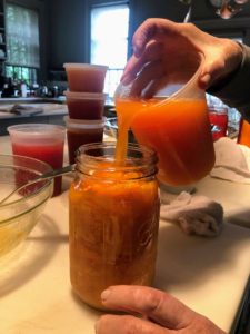 Next, I add tomato juice to fill the jar, leaving a 1/2-inch of space at the top of each jar's neck, so there is room for expansion when it is heated.
