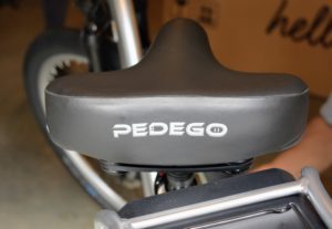 The seat has a soft saddle with a suspension seat-post for extra cushioning. The seat will be adjusted to my height later. The seat-post is secured with a very durable clamp bolt.