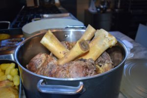 Several meats are used for this pot-au-feu including veal shanks, beef shanks, short ribs, Italian sausage and marrow bones. The meats are slowly braised to cook the meat and melt the marrow.