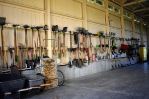 The crew also cleaned and organized the giant Equipment Barn. All the many gardening tools are hung so that they are easy to find. Dirt is rinsed off outdoors before tools are put away.