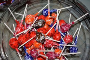 Tootsie Pops are hard candy lollipops filled with chocolate-flavored chewy Tootsie Roll. They were invented in 1931 by Lukas R. "Luke" Weisgram, an employee of The Sweets Company of America, which eventually changed its name to Tootsie Roll Industries in 1969.