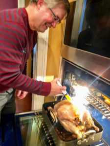 Here's Dorian's brother following instructions and basting the turkey from the Martha & Marley Spoon Turkey box kit.