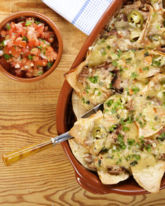 In this recipe, aptly named “Crazy Nachos,” Emeril puts his classic roux to the test, making a decadent queso for his Pulled Pork-Smothered Nachos.