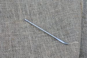 The needles are specially designed for sewing jute. These five-inch long needles have large eyes and bent tips.