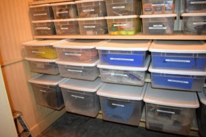 Smaller bins are placed on higher shelves, and larger ones on lower shelves. If possible, keep items off the floor, so it is easier to walk about the space.