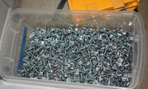 Here is our bin of appropriate nuts and screws for the shelves - found quickly in our newly organized Equipment Barn Supply Closet.