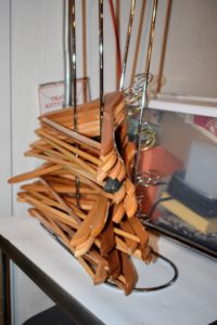 Extraneous hangers are removed from the racks and stored for later use. Using sturdy wood hangers, or velvet ones for more delicate pieces, will add to the longevity of your clothing.