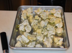The florets are placed on a rimmed baking sheet, tossed with two-tablespoons of olive oil, a half-teaspoon of salt and some pepper. The cauliflower is then placed into a 450-degree Fahrenheit oven and roasted until tender and golden brown.