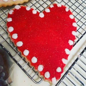 Here is a red one with white dots of frosting around the edge. For this cookie, I just colored the sugar with red food coloring and came out with this bold and festive Valentine red.