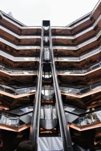 There is one elevator on the south side which can take visitors right to the top. Copper-colored metal wraps the soffits, reflecting those standing or walking in the plaza below.