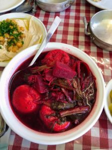This is kubbeh, or kibbeh, in beet soup. Kubbeh is a Levantine dish made of bulgur, minced onions, and finely ground lean beef, lamb, goat, or camel meat with Middle Eastern spices, often served in soups.