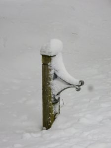 This post holds a hose during warmer months. It is also covered with snow.