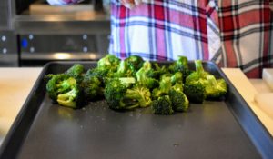 Meanwhile, the broccoli is prepared - trimmed and cut into one-inch florets, tossed with olive oil and salt, and then roasted.