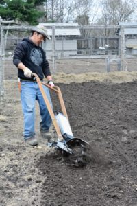 Here's Dawa tilling the soil in a patch where the boxwood will be planted.