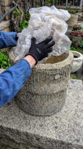 First, I put in a layer of bubble wrap - this is a great way to reuse and repurpose all that bubble wrap that may have accumulated over the winter months from package deliveries. Filling the bottom of large planters with something other than soil also benefits plantings in several ways - it is more economical, easier to move, and better for drainage and root growth.