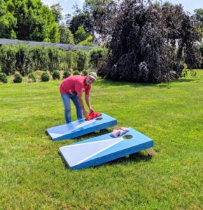 Fernando sets up the corn hole beanbag toss on my Party Lawn. We made these corn hole platforms on my television show. http://www.marthastewart.com/996829/cornhole-beanbag-toss-game