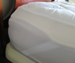 I also like to fit my beds with lamb's wool mattress covers. Look closely and the mattress pad fits perfectly over the cover, keeping everything in place.