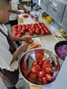 Aron's brother, Kevin, the sous-chef, prepares a tray of tomatoes.