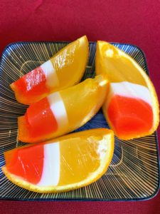 This dessert used citrus peels filled with gelatin in bright red, white and orange.
