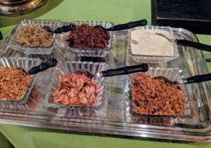 Condiments for the rice include fried dilis or smelt fish, chicken adobo flakes, tinapa smoked fish flakes, fried shallots, and fried garlic.