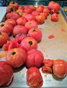 The process takes a bit of time, but Sanu works efficiently. She peels these tomatoes while another batch is on the stove.