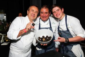 Chef Daniel Boulud, Emeril, and EJ stopped for this quick photo with a bowl of black truffles. (Photo by Astrid Stawiarz/Getty Images)