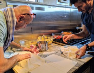 Brushing each sheet of phyllo with butter is important so that it bakes golden, crisp, and flaky. Both Chef Pierre and Chef Alain pull the edges of the phyllo to cover the mixture and then add more phyllo to cover the top completely.
