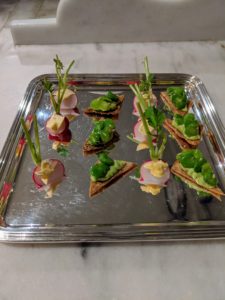As guests enjoyed their cocktails, hors d'oeuvres were passed around on silver platters.