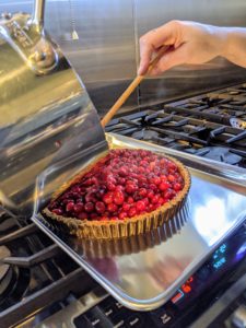 The filling for the Cranberry Tart includes cranberries, sugar, jelly, cognac, and gelatin. Then it is poured into the crust and chilled for at least one hour.