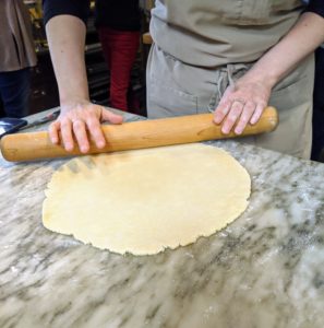 Molly Wenk, who does a lot of the baking for my television shows and event appearances, came up to help me make the pies. Here she is rolling out one of the discs. When rolling, make sure there are no cracks. To fit a nine-inch pie plate, roll out an 11-inch round that's about 1/8-inch thick.