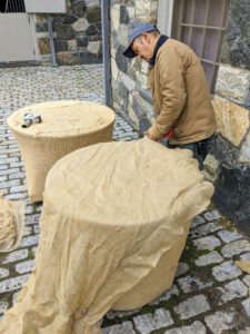 Here is Chhiring working on the second birdbath in this courtyard. It doesn't take too long to cover the piece, but because the burlap is exposed to the elements for several months, Chhiring does this task very carefully.