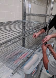 I have long used these metal wire shelving units. They are durable and easy to install anywhere. Enma and Carlos adjust the shelving to accommodate a collection of filing containers along one wall of this basement.