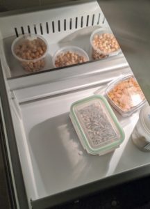 Then she places all the items back - these containers are filled with nuts. To preserve the quality of nuts, always keep them away from onions and other high-odor foods, so they don't absorb any of the smells. Store shelled or unshelled nuts in the freezer for a year or even more.
