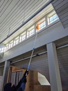 This loft has high ceilings and lots of windows. It needed a good cleaning, so the outdoor grounds crew began at the top and worked its way down. Here's Phurba dusting one row of windows. Hay creates a lot of dust, so this is done on a regular basis.