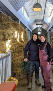 Carlos and Helen stop for this quick photo after the tarp wall is completed, all the hay is stacked, and the floors cleaned.