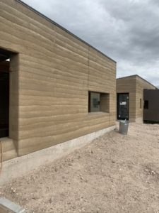 The color of rammed earth walls is determined by the earth and aggregate used. The ramming process is done layer by layer and shows the appearance of horizontal stratification. Rammed earth is very strong and beautiful.