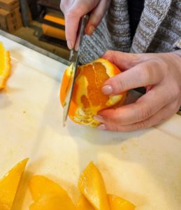 And cuts the peel and white pith off the orange and cuts it into two-inch pieces.