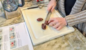 The next smoothie we made is the Cocoa-Coco Loco Smoothie. Here is Shqipe pitting the dates. Dates are not only tasty but also a good source of antioxidants.